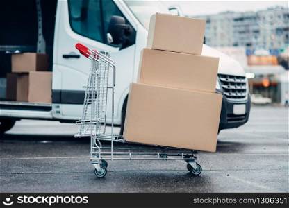 Trolley with carton boxes against truck . Distribution business. Cargo delivery. Empty, clear containers. Mail logistic and post service