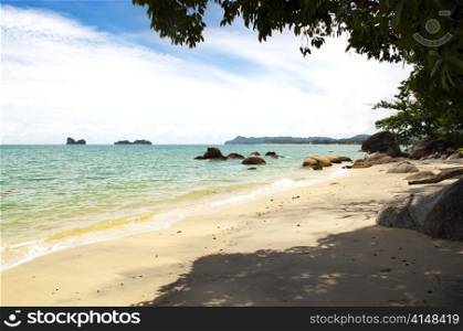 Tropical beach and coastline with waves lapping