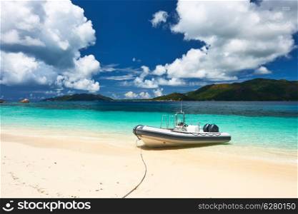 Tropical beach at Seychelles with inflatable boat