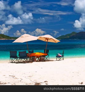 Tropical beach at Seychelles with picnic table and chairs