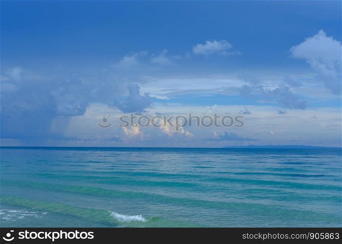 Tropical beach. Blue sky and clear water with white clouds.