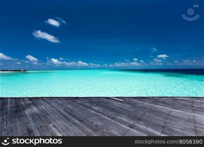 tropical beach in Maldives with few palm trees and blue