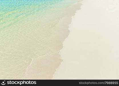 tropical beach in Maldives with few palm trees and blue lagoon