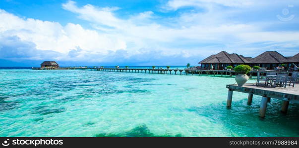 tropical beach in Maldives with few palm trees and blue lagoon