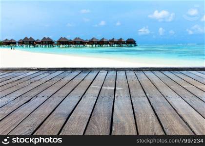 tropical beach in Maldives with few palm trees and blue lagoon