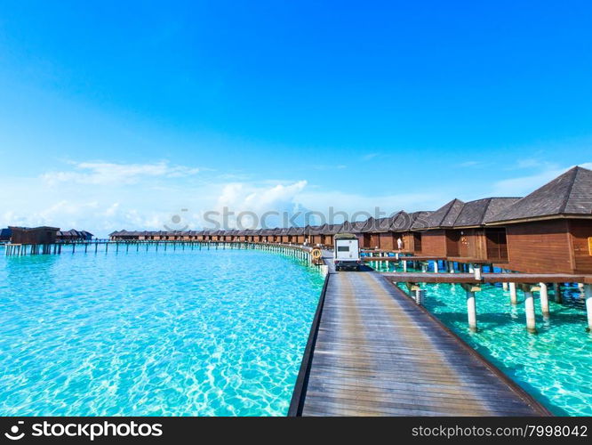 tropical beach in Maldives with few palm trees and blue lagoon