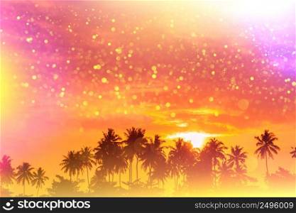 Tropical beach palms at sunset silhouettes fairytale stylized with colofrul light leaks and gold glitter particles