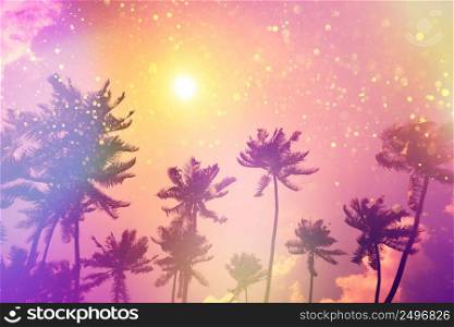 Tropical beach palms at sunset silhouettes party fairytale stylized with colofrul light leaks and gold glitter particles