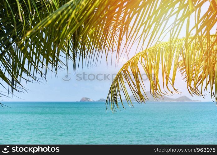 tropical beach sea with coconut palm tree sunlight ocean on the summer blue sky and islands / Vacation holidays background wallpaper