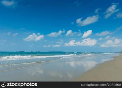 Tropical beach with clear water , blue sky and speed boats