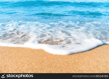 Tropical beach with sand and sea wave at background. Macro shot. Tropical beach with sand and sea