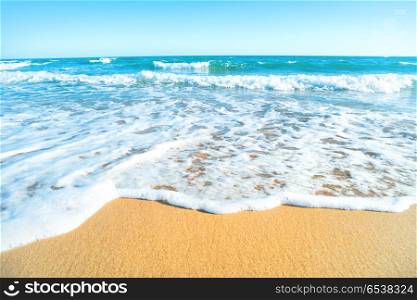 Tropical beach with sand and sea wave at background. Macro shot. Tropical beach with sand and sea