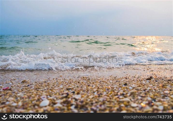 Tropical beach with wave,blue sky on golden beach sand in sunset light