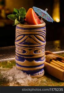 Tropical cocktail tiki bar style. Alcoholic, non-alcoholic drink-beverage at the bar.