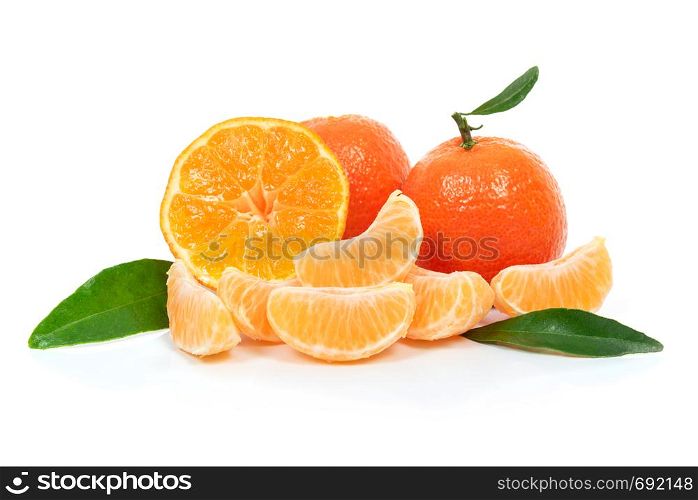 Tropical fruit composition - fresh fruits and pieces of orange or tangerine with leaves isolated on a white background