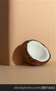 Tropical fruit concept, Halves of fresh white coconut on cream color background.