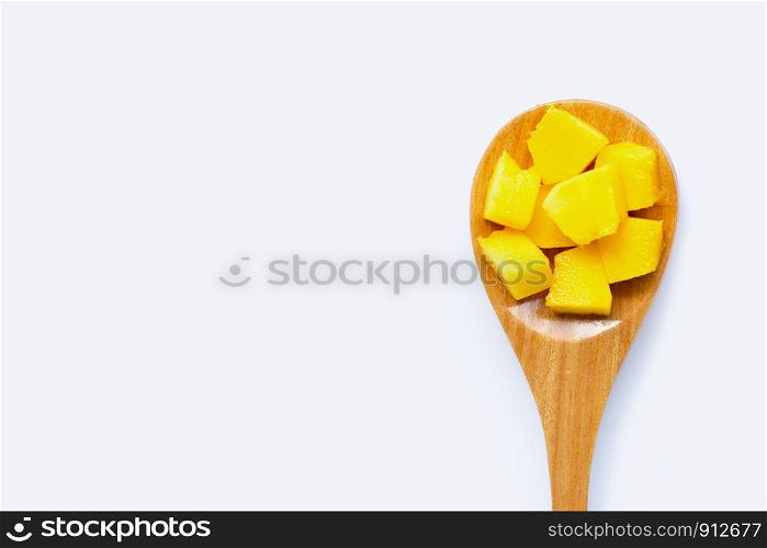 Tropical fruit, Mango cube slices with wooden spoon on white background. Copy space