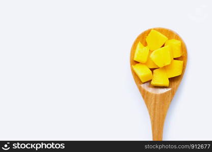 Tropical fruit, Mango cube slices with wooden spoon on white background. Copy space