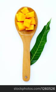 Tropical fruit, Mango on wooden spoon, white background. Top view