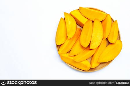 Tropical fruit, Mango slices on wooden plate on white background. Copy space
