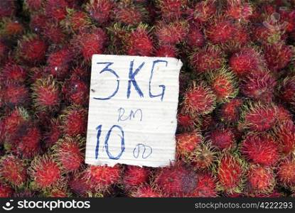 tropical fruit rambutan on the table, market in Kemaman, Malaysia