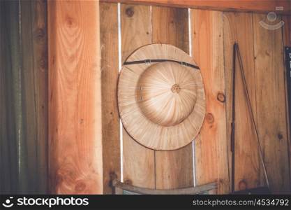 Tropical hat hanging on a wooden wall in a hut