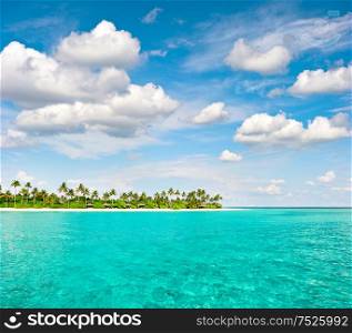 Tropical island beach with palm trees and cloudy blue sky. Nature landscape