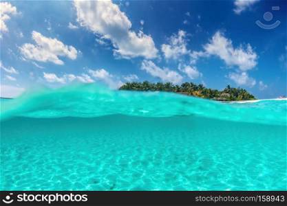 Tropical island on Indian Ocean, Maldives. Half underwater shot, clear turquoise water. Tropical island on Indian Ocean, Maldives. Half underwater shot