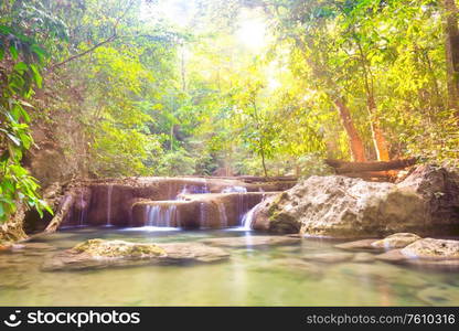 Tropical landscape with beautiful cascades of waterfall and green trees in wild jungle forest. Erawan National park, Kanchanaburi, Thailand