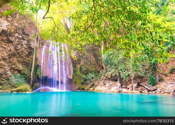 Tropical landscape with beautiful waterfall, emerald lake and green tree in wild jungle forest. Erawan National park, Kanchanaburi, Thailand