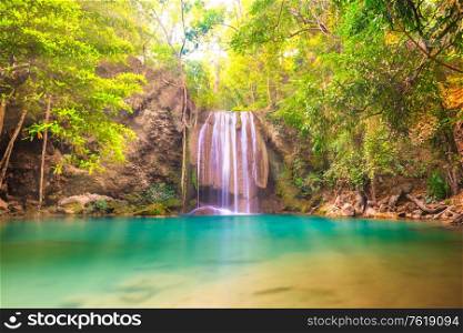 Tropical landscape with beautiful waterfall, emerald lake and green tree in wild jungle forest. Erawan National park, Kanchanaburi, Thailand