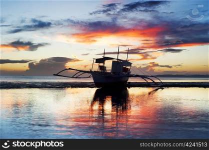 Tropical landscape with traditional Philippines boat at sunset, Philippines