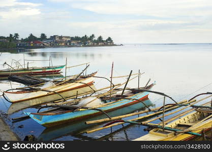 Tropical landscape with traditional Philippines fishermans boats and village. Donsol, Philippines