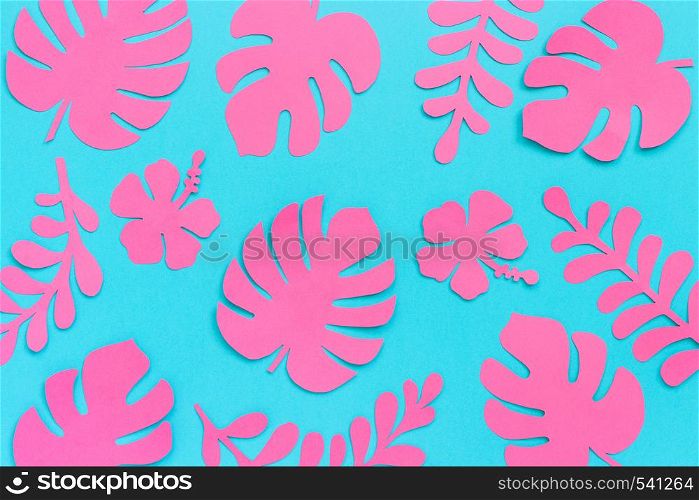 Tropical leaves pattern. Trendy pink tropical leaves of paper on blue background. Flat lay, top-down composition, creative paper art.. Tropical leaves pattern. Trendy pink tropical leaves of paper on blue background. Flat lay, top-down composition, creative paper art