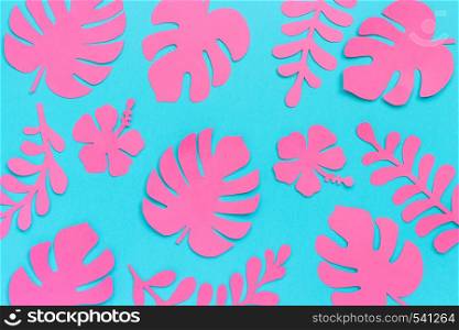 Tropical leaves pattern. Trendy pink tropical leaves of paper on blue background. Flat lay, top-down composition, creative paper art.. Tropical leaves pattern. Trendy pink tropical leaves of paper on blue background. Flat lay, top-down composition, creative paper art