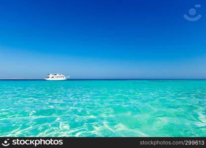 tropical Maldives island with white sandy beach and sea