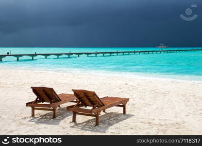 tropical Maldives island with white sandy beach and sea