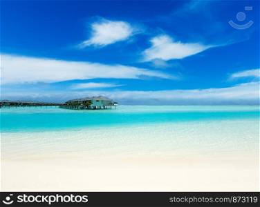 tropical Maldives island with white sandy beach and sea.
