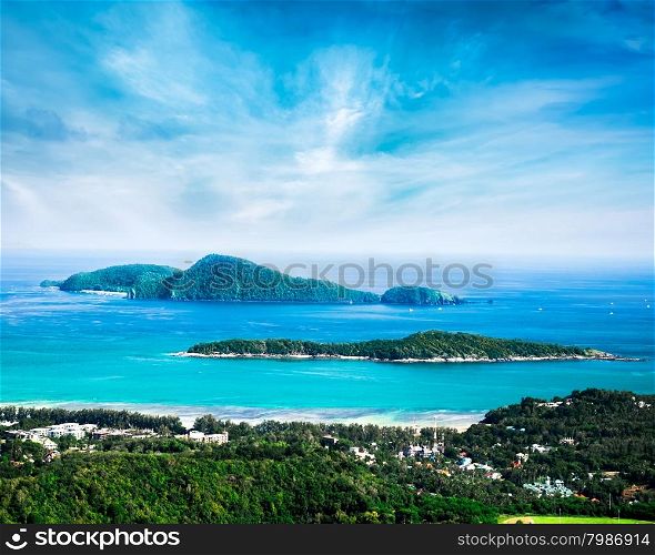 Tropical ocean landscape with Koh Kaeo island at turquoise ocean waves and boats near Ya Nui beach. Rawai, Phuket, Thailand