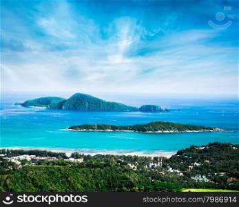 Tropical ocean landscape with Koh Kaeo island at turquoise ocean waves and boats near Ya Nui beach. Rawai, Phuket, Thailand