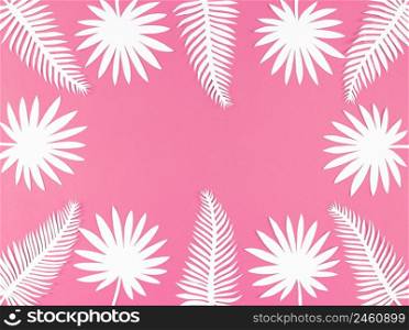 Tropical paper leaves on a pink background, flat lay with copy space.. Tropical paper leaves on pink background, flat lay with copy space.
