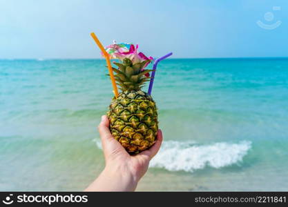 Tropical pineapple cocktail drink at the ocean beach. Tropical pineapple cocktail