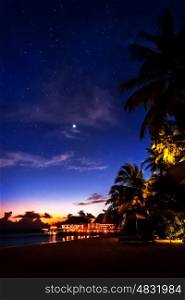Tropical resort at night, beautiful nighttime scene og a romantic beach, peaceful island landscape