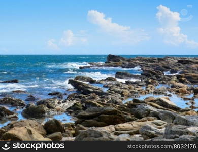 Tropical rocky beach with coconut palm trees, sandy beach and ocean. Tangalle, Southern Province, Sri Lanka, Asia.