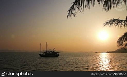 Tropical sunset with boat