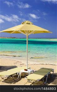 Tropical vacation - beds and umbrella on a beach