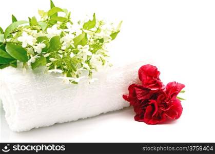 Tropical white and fragrant flower, Wild Water Plum (Wrightia religiosa) and red Hibiscus with towel on spa theme