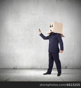 Trouble in business. Troubled businessman with carton box on head expressing emotions