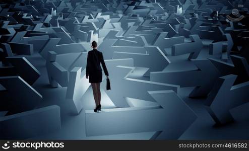 Troubled businesswoman finding way out. Puzzled businesswoman in labyrinth choosing her way direction