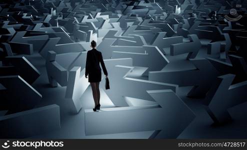 Troubled businesswoman finding way out. Puzzled businesswoman in labyrinth choosing her way direction